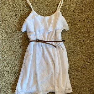 Short white dress with tan belt.